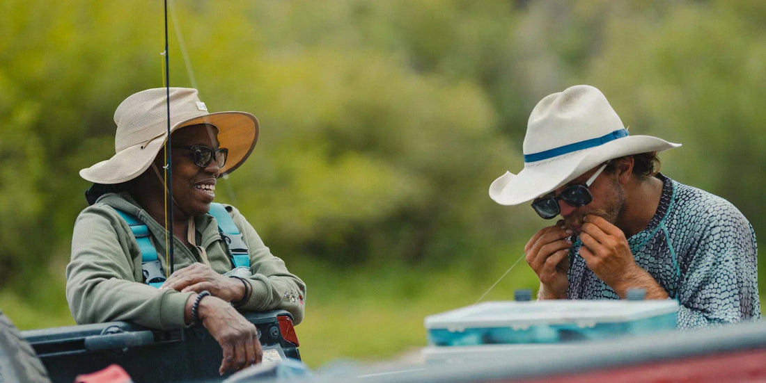 Two veterans sharing a moment of connection on the water during a Project Healing Waters fly fishing outing