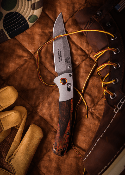 Custom Benchmade Crooked River folding knife with a company logo laser-marked on the blade, styled as a premium corporate gift.