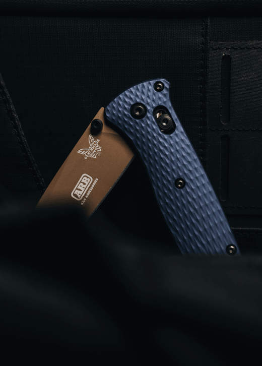 Custom Benchmade Bugout folding knife with a blue handle and company logo laser-marked on the blade for corporate gifting.